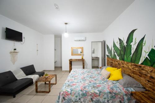 a bedroom with a large bed and a couch at Isla Venados Renta Vacacional in Mazatlán