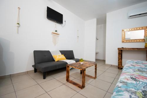 a living room with a couch and a table at Isla Venados Renta Vacacional in Mazatlán