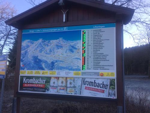 a sign in front of a snow covered mountain at fun4all-holidayhome in Medebach