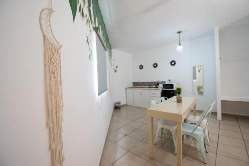 a dining room and kitchen with a table and chairs at Isla Venados Renta Vacacional in Mazatlán