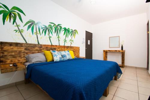 a bedroom with a bed with a blue blanket at Isla Venados Renta Vacacional in Mazatlán