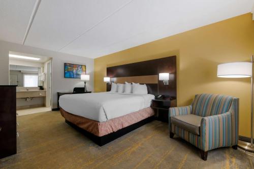 a large hotel room with a bed and a chair at Best Western Inn Of Palatka in East Palatka