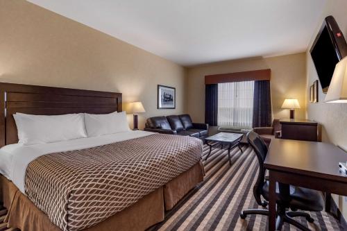 a hotel room with a bed and a desk at Best Western Plus Meridian in Lloydminster