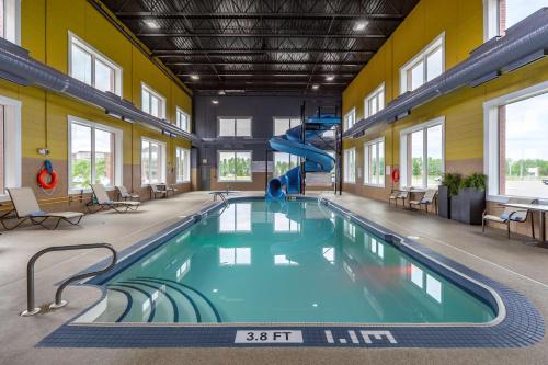 a swimming pool with a slide in a building at Best Western Plus Meridian in Lloydminster