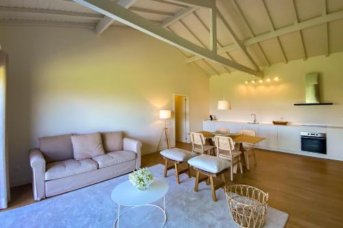 a living room with a couch and a table at The FarmHouse II - Uma quinta deslumbrante in Felgueiras