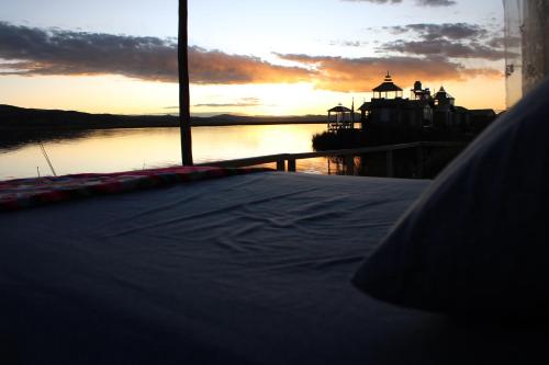a view of the sunset from the deck of a boat at TITICACA JALTAWI LODGE in Puno