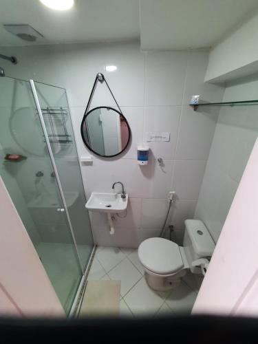 a bathroom with a shower and a toilet and a mirror at Cantinho dos Dalto in Itatiaia