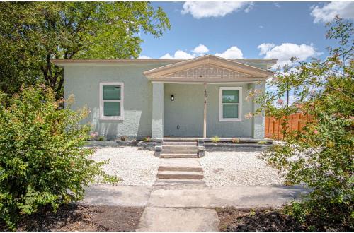 a green house with a pathway leading to it at Cozy and Lovely 2BR 2BA Apt#A Near Lively Downtown in San Antonio