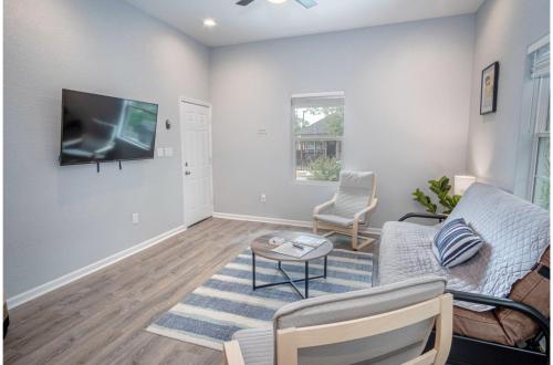 a living room with a couch and a tv at Cozy and Lovely 2BR 2BA Apt#A Near Lively Downtown in San Antonio