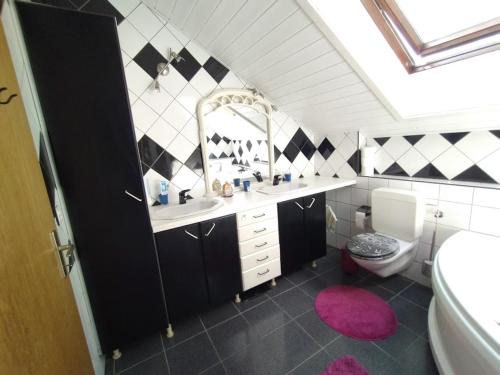 a bathroom with a sink and a toilet and a mirror at Chez l'Eveline Chambre Libellule in Les Bois