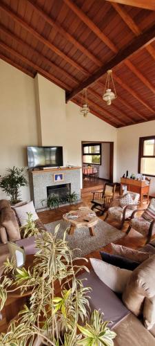 a large living room with couches and a fireplace at Pousada Valparaiso in Petrópolis