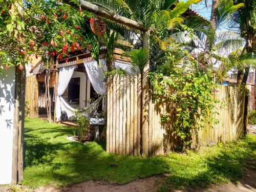 a wooden fence in front of a house at Casa Marcela in Barra Grande