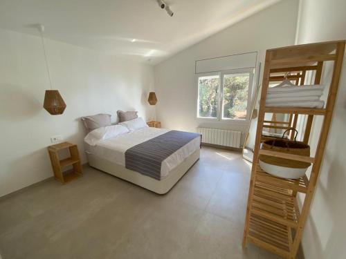 a bedroom with a bunk bed and a ladder at Loft Casa Blanca in Blanes