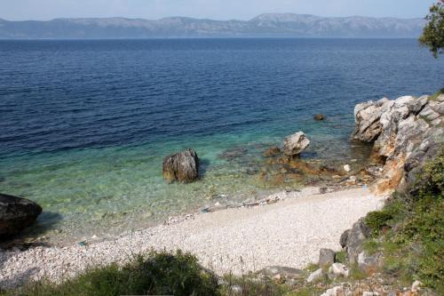 a beach with a large body of water at Apartments by the sea Kozarica, Mljet - 4950 in Kozarica
