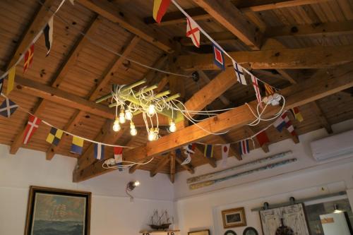 a chandelier hanging from a wooden ceiling with flags at Geronimo Guest House Belém in Lisbon