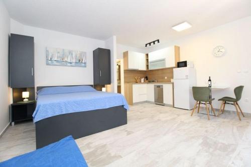 a large bedroom with a bed and a kitchen at Apartments by the sea Mandre, Pag - 6284 in Kolan