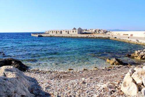 a rocky beach with a pier and the ocean at Holiday house Lastovo - 8289 in Lastovo