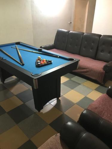 Una mesa de billar en una sala de estar con un sofá. en Departamentos Sarmiento, en San Luis