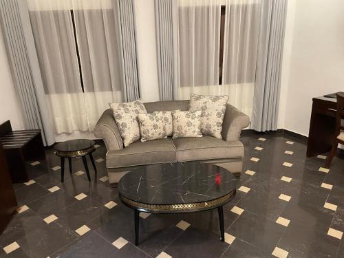 a living room with a couch and a table at HOTEL LES ARCADES in Abomey-Calavi