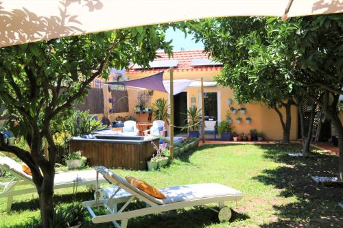 a garden with a hot tub and a chair at Geronimo Guest House Belém in Lisbon
