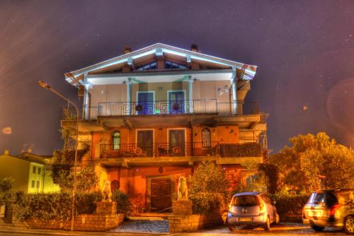 a house with cars parked in front of it at Guest House Qui Dormì L'Etrusco in Canino