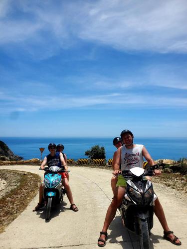 a group of people riding motorcycles on a road at Monkey Homestay & Bar in Tân Hiệp