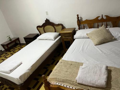 two beds sitting next to each other in a room at Casa Grande in Medellín