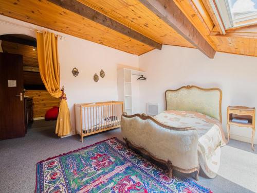 a bedroom with a large bed and a crib at Inviting holiday home in Miremont with garden in Miremont