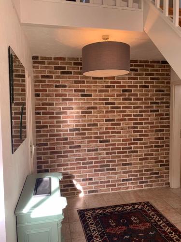 a room with a brick wall and a light at Lovely Meadow House in the land of Croix Scaille in Gedinne