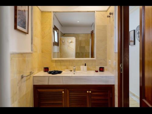 a bathroom with a sink and a mirror at VILLA HELEN in Playa Blanca