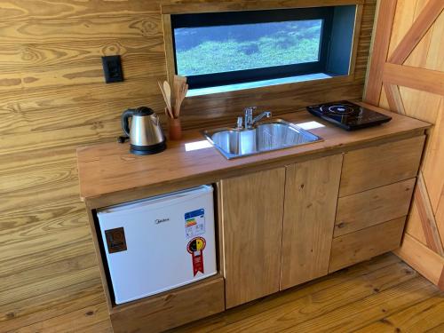 a small kitchen with a sink and a sink at Estalagem Santa Clara in Urubici