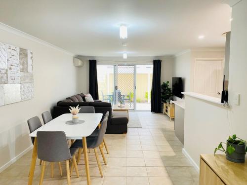 a living room with a table and a couch at By the Beach in Broadwater