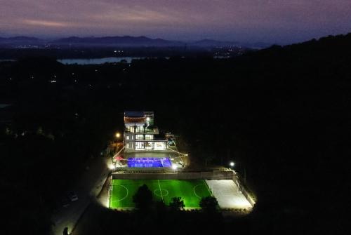 a building with lights on it at night at Cung Mây Villas - Venue Travel in Ba Vì