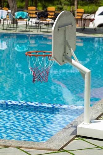 a basketball hoop in front of a swimming pool at Cung Mây Villas - Venue Travel in Ba Vì