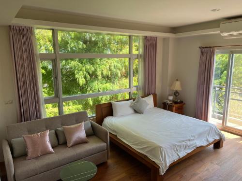 大義村的住宿－夢想成真櫻之宿，一间卧室配有一张床、一张沙发和一个大窗户