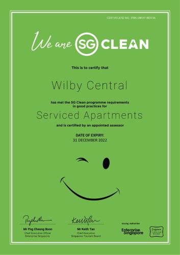 a green certificate with a smiley face at Wilby Central Serviced Apartments in Singapore
