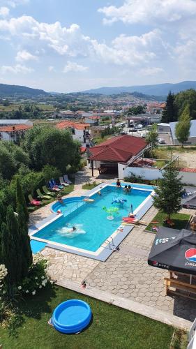 an overhead view of a large swimming pool with people in it at Hotel Zenit Satovcha in Satovcha