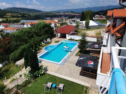 an overhead view of a swimming pool with people in it at Hotel Zenit Satovcha in Satovcha