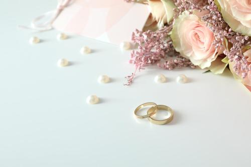 a table with a bouquet of flowers and two wedding rings at St Kilda Style - Stunning 3 Bedroom House in Melbourne