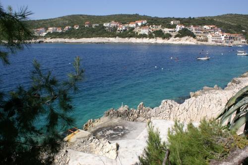 a large body of water with a beach and buildings at Apartment Zavalatica 189b in Zavalatica