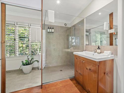a bathroom with a sink and a mirror at Mavis's Cabins @ Mt Warning in Uki