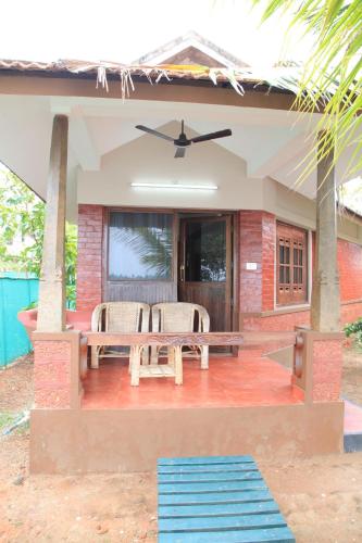 a patio with a table and chairs on a house at Cherai Beach Resorts in Cherai Beach