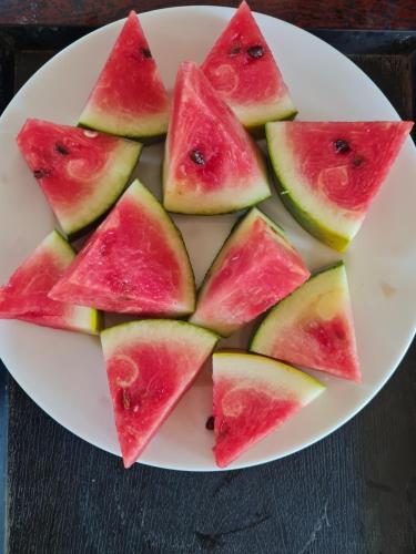 a plate of watermelon slices on a table at Hoang Sa Beach Healing Home in Quang Ngai