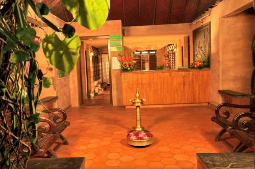 a hallway of a home with a cross on the floor at Cherai Beach Resorts in Cherai Beach