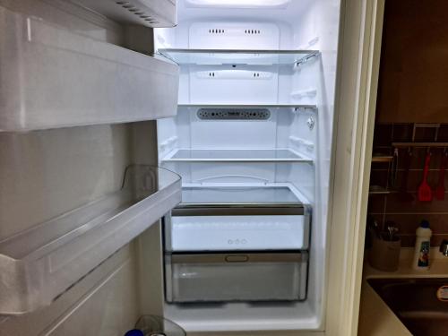 an empty refrigerator with its door open in a kitchen at Gimcheon Gumi KTX Yulgokdong Apartment in Gimcheon