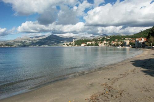 a view of a beach with mountains in the background at Studio Lopud 14013a in Lopud Island