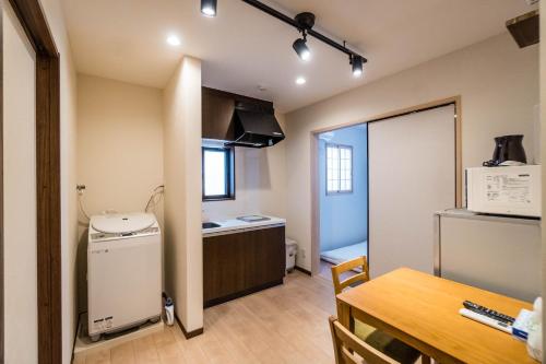 a small kitchen and dining room with a table at HANASTAY花渓居 · 丘（OKA) in Osaka