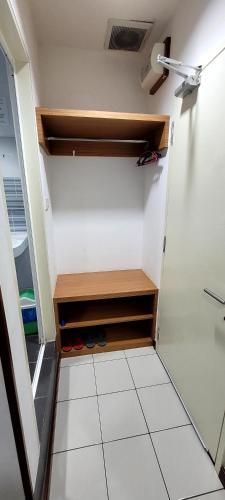 a walk in closet with shoes in it at Api-Api GuestHouse in Kota Kinabalu