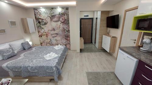 a small room with a bed and a tv at Sunrise City A1, Sarafovo in Burgas City