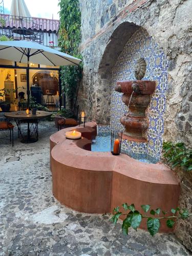 a fountain in a stone wall with a statue at Parador de Antigua in Antigua Guatemala